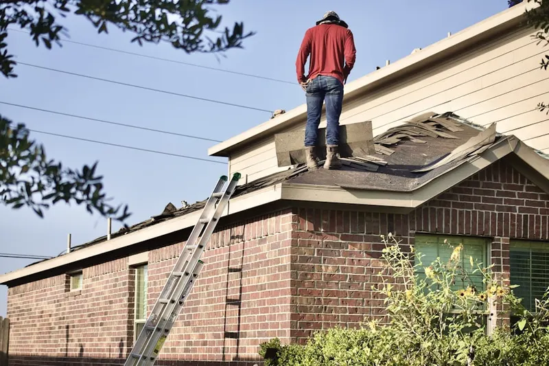 Professional roofer working on a residential roof in Beaumeade